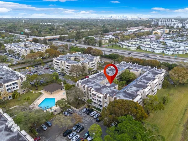 an aerial view of lake and residential houses with outdoor space