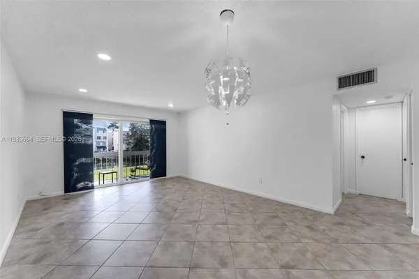 a view of an empty room with a chandelier