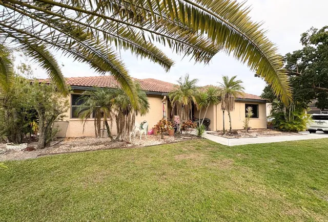 a view of a house with swimming pool and sitting area