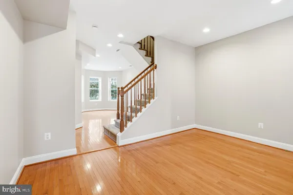 a view of room with stairs and wooden floor