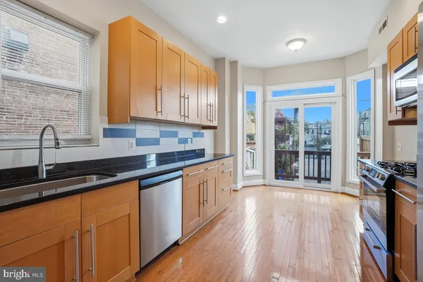 a kitchen with granite countertop a sink and cabinets