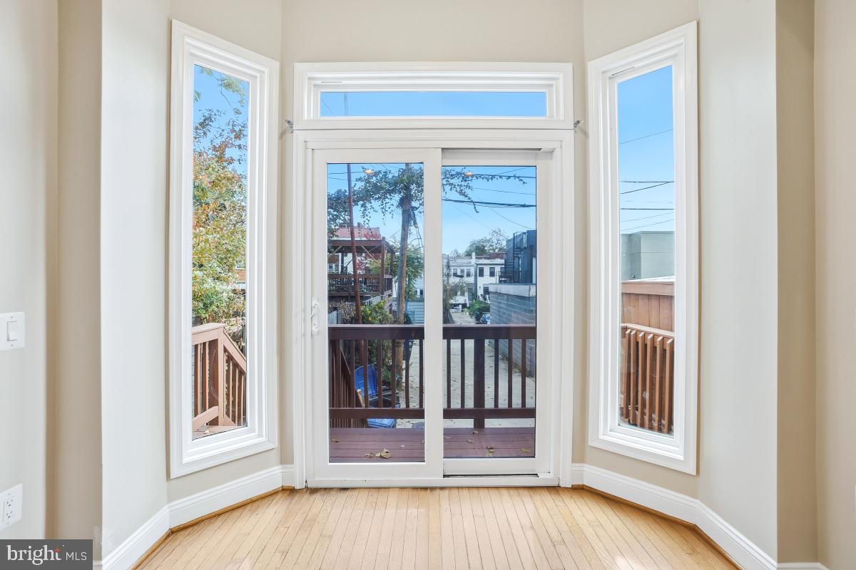 3117 11th Street Northwest Washington, DC 20010 - Photo 20 of 35 a view of a bedroom with wooden floor and windows