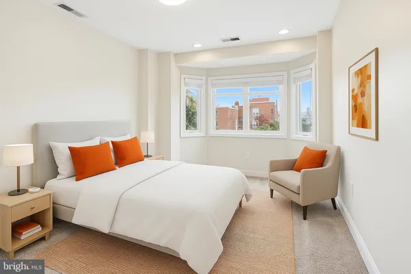 a bedroom with a bed and a couch