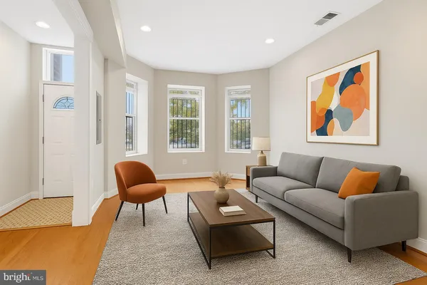 a living room with furniture and a large window