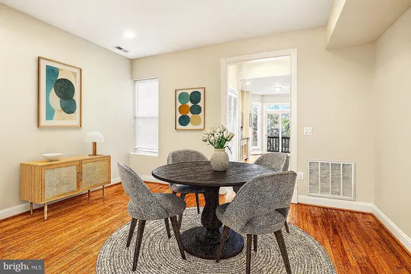 a view of a dining room with furniture and wooden floor