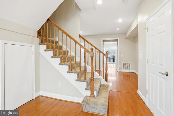 a view of entryway and hall with wooden floor