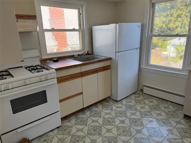 a kitchen with a stove cabinets and a refrigerator