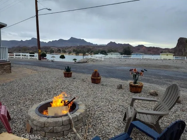 a view of a lake with a terrace chairs