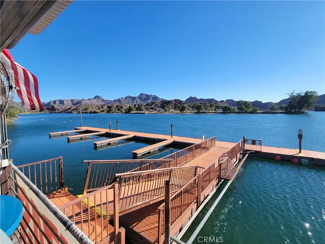 a view of roof deck with lake view and mountain view