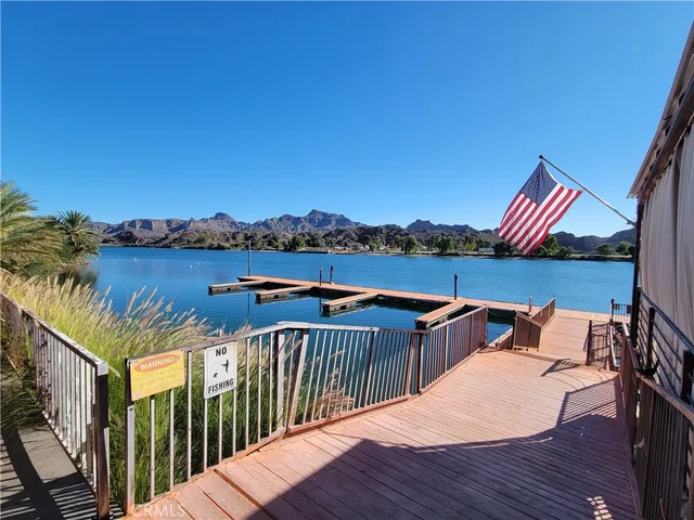 a balcony with wooden floor and outdoor space