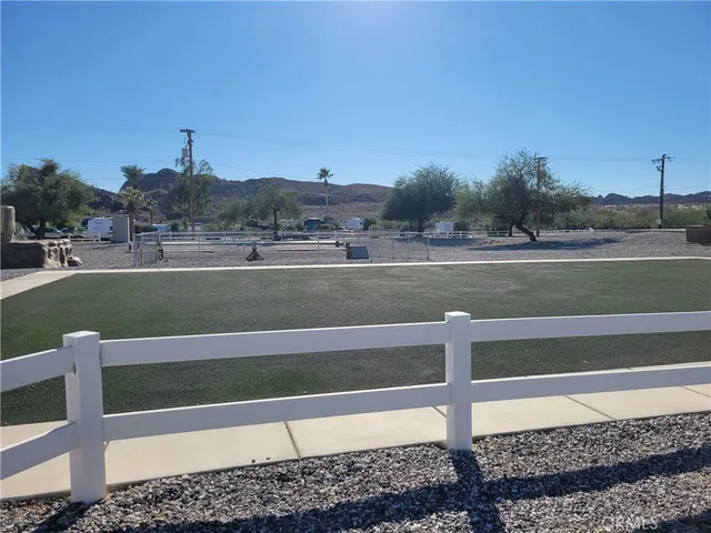 a view of a house with a yard and large tree