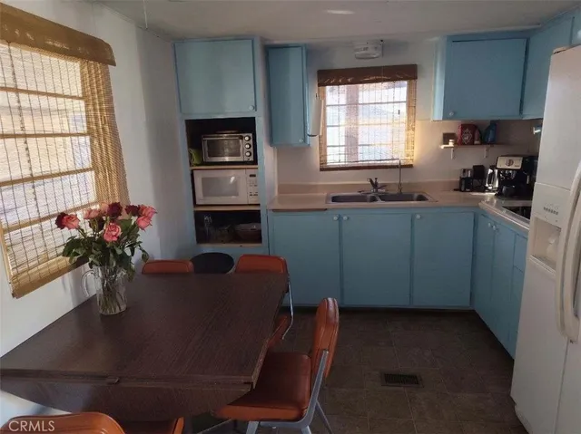 a dining room with furniture window and a kitchen