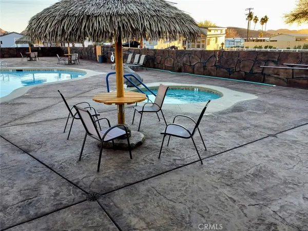 a swimming pool with outdoor seating and yard