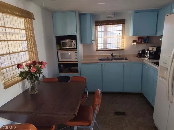 a dining room with furniture window and a kitchen