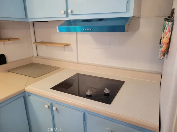 a kitchen with a cabinets and white appliances