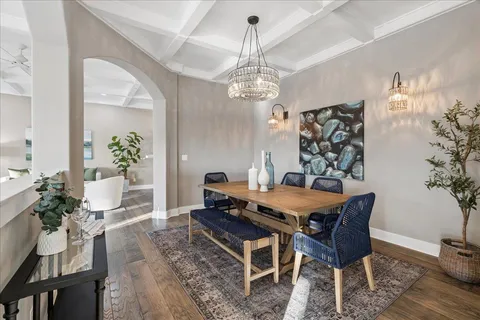 a kitchen with stainless steel appliances granite countertop a refrigerator a stove top oven a sink dishwasher and white cabinets with wooden floor