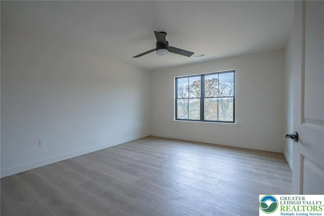 a view of a hallway with entryway window and stairs