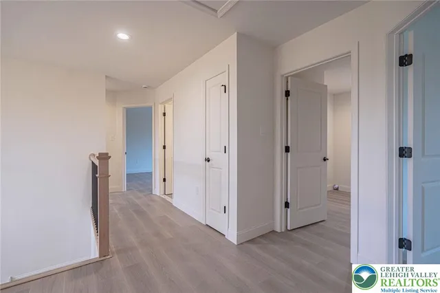 a kitchen with stainless steel appliances granite countertop a sink a stove and a wooden floors