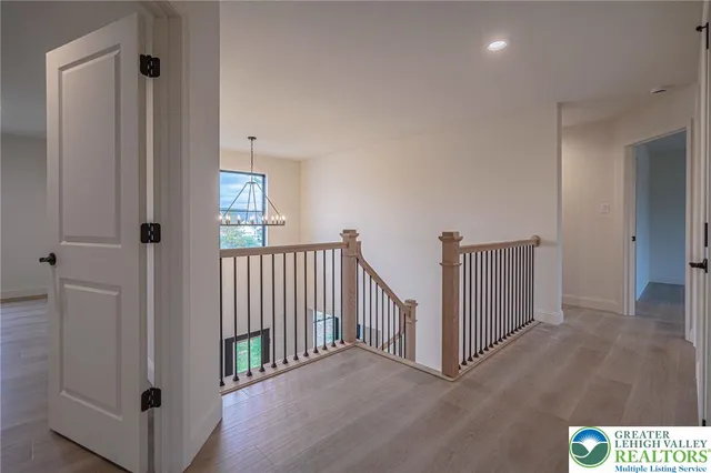 a kitchen with stainless steel appliances white cabinets and a stove top oven