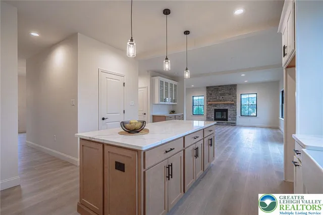 an empty room with wooden floor and fireplace