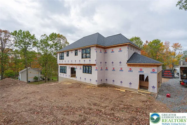 an aerial view of residential houses with outdoor space and trees