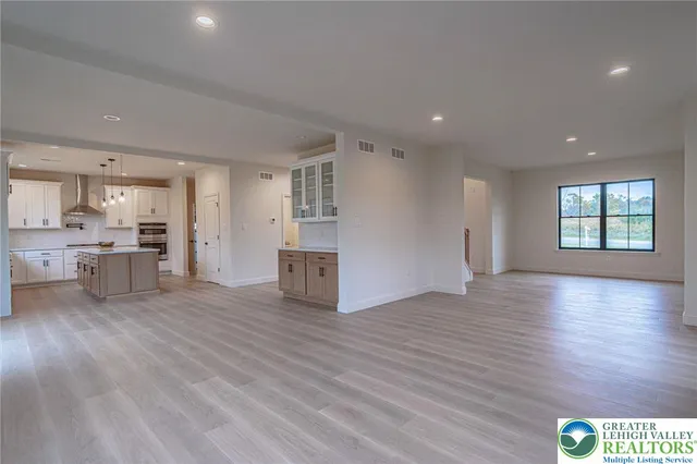 a view of a house with a yard and fence