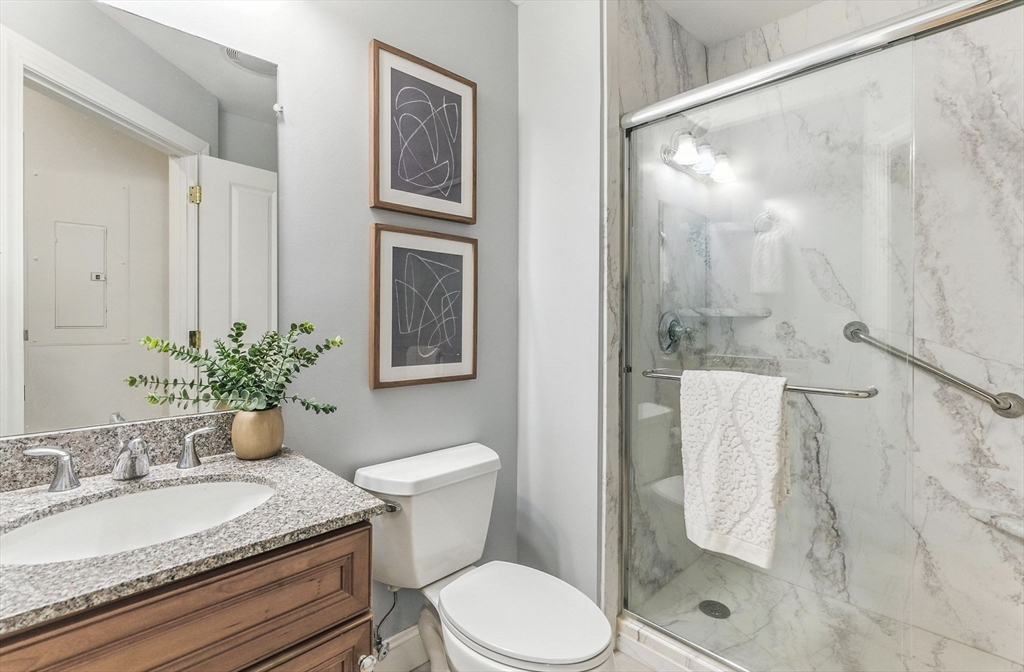 248 Albion Street, Unit 211 Wakefield, MA 01880 - Photo 13 of 24 a bathroom with a granite countertop sink toilet and shower