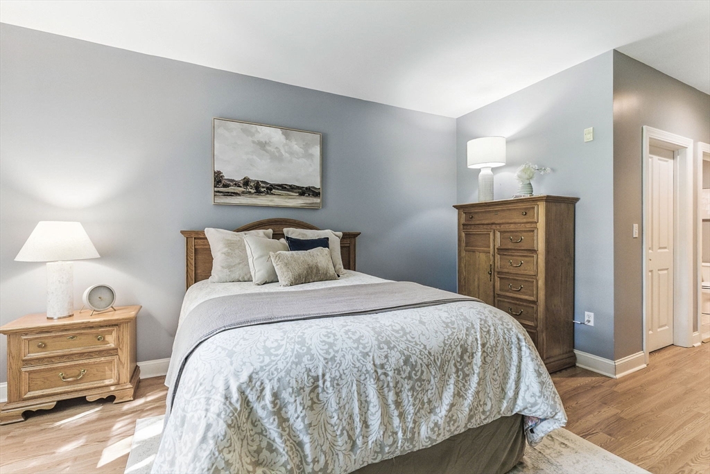 248 Albion Street, Unit 211 Wakefield, MA 01880 - Photo 16 of 24 a bedroom with a bed and a dresser