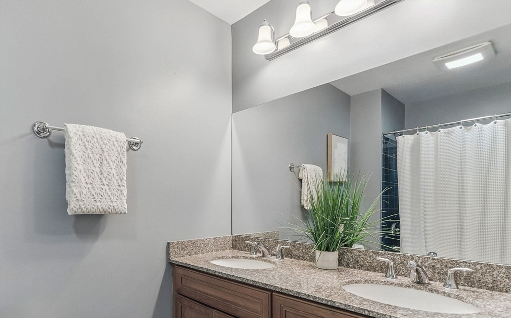 248 Albion Street, Unit 211 Wakefield, MA 01880 - Photo 17 of 24 a bathroom with a granite countertop sink and a mirror