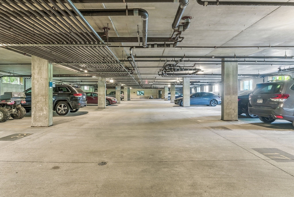 248 Albion Street, Unit 211 Wakefield, MA 01880 - Photo 19 of 24 a view of parking garage with cars