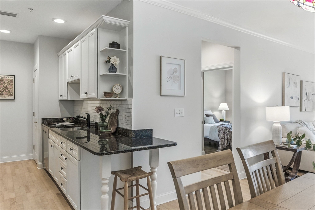 248 Albion Street, Unit 211 Wakefield, MA 01880 - Photo 7 of 24 a kitchen with stainless steel appliances granite countertop a stove a sink and a refrigerator