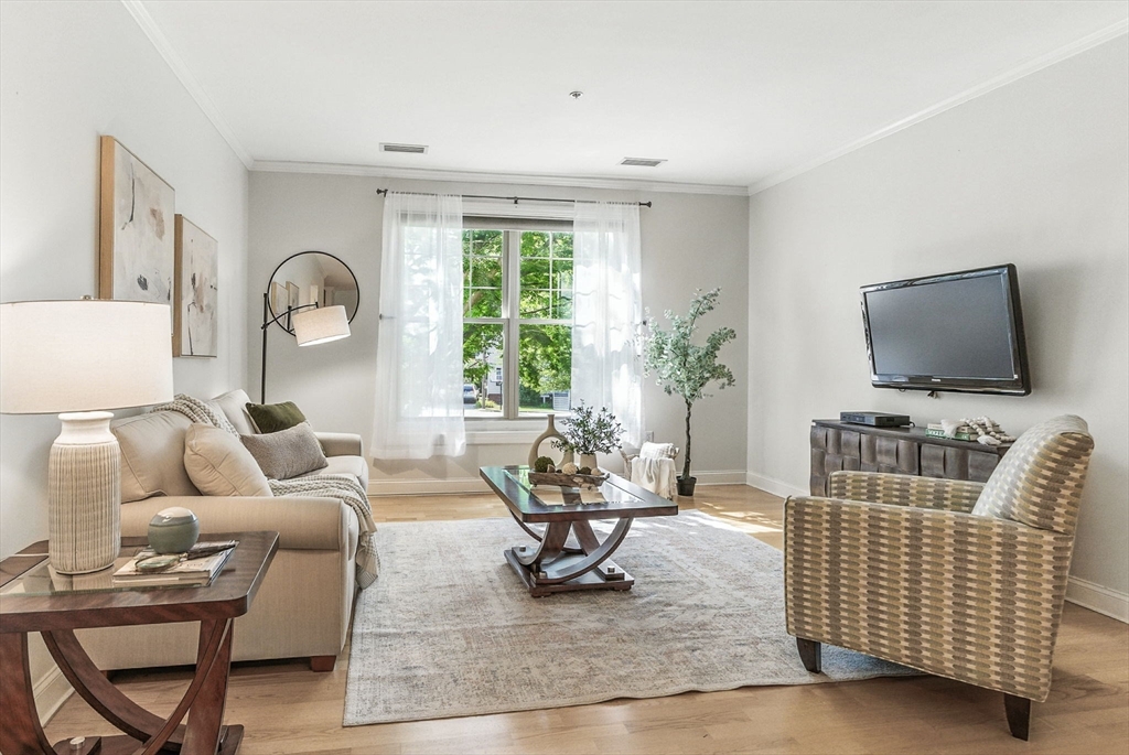 248 Albion Street, Unit 211 Wakefield, MA 01880 - Photo 9 of 24 a living room with furniture and a flat screen tv
