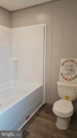 a bathroom with a toilet and a bathtub