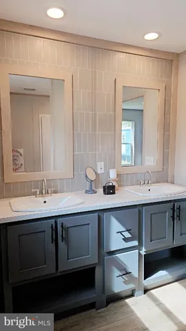 a bathroom with a double vanity sink a and mirror