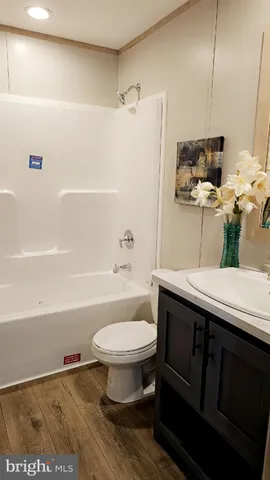 a bathroom with a sink a toilet and bathtub