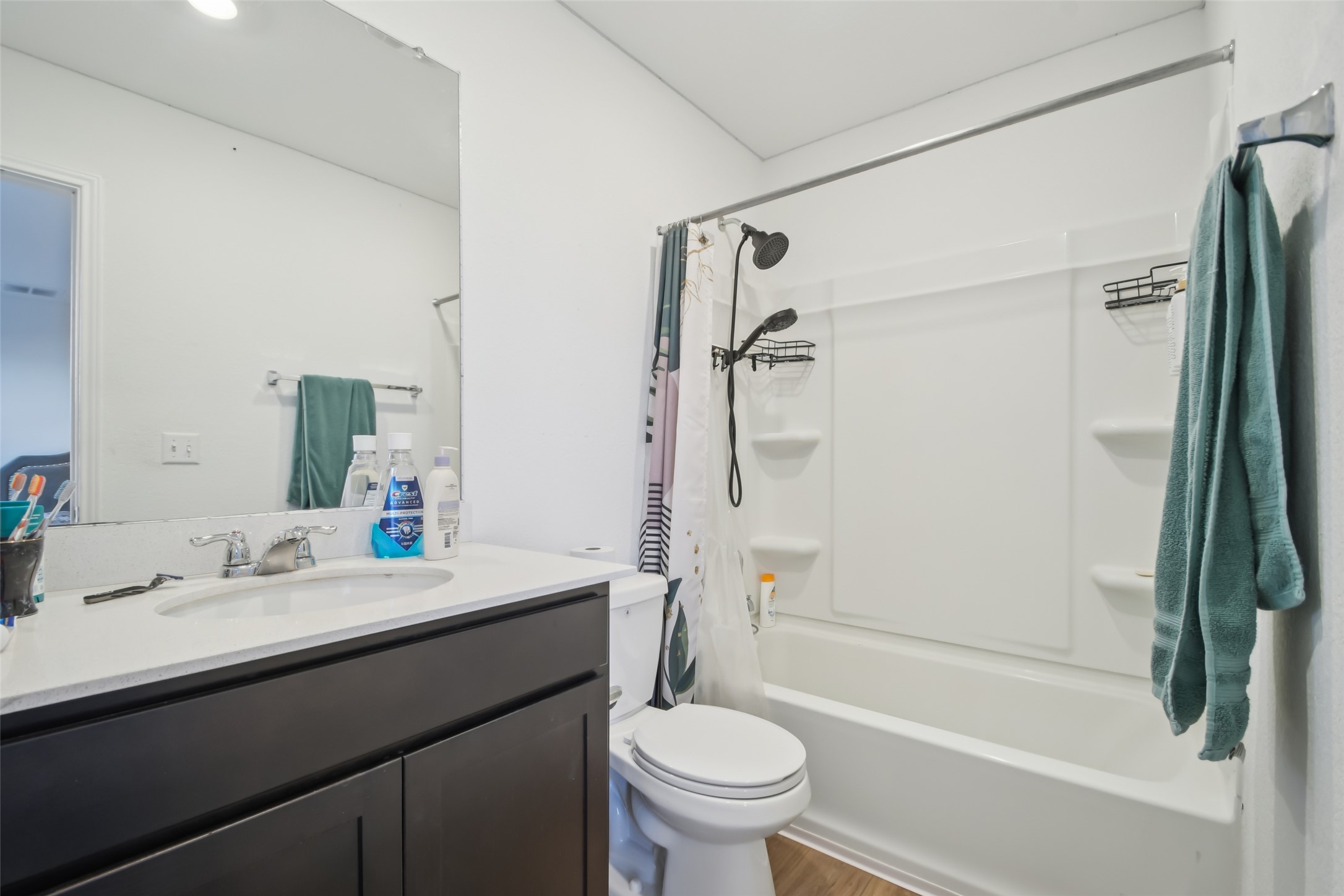 857 Powell Kyle, TX 78640 - Photo 21 of 28 Full bath featuring vanity, shower / tub combo, and wood finished floors