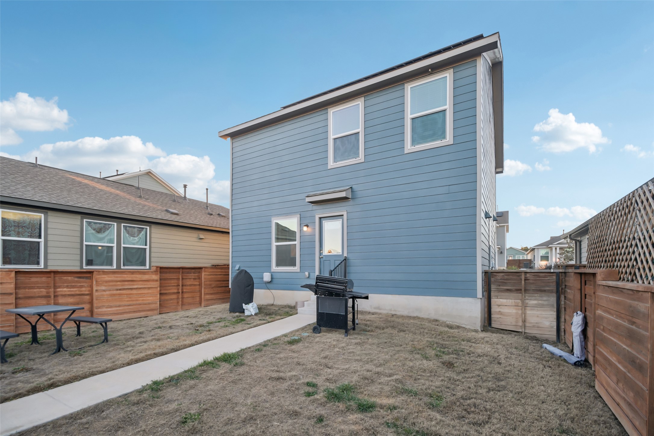 857 Powell Kyle, TX 78640 - Photo 25 of 28 Back of house with a fenced backyard