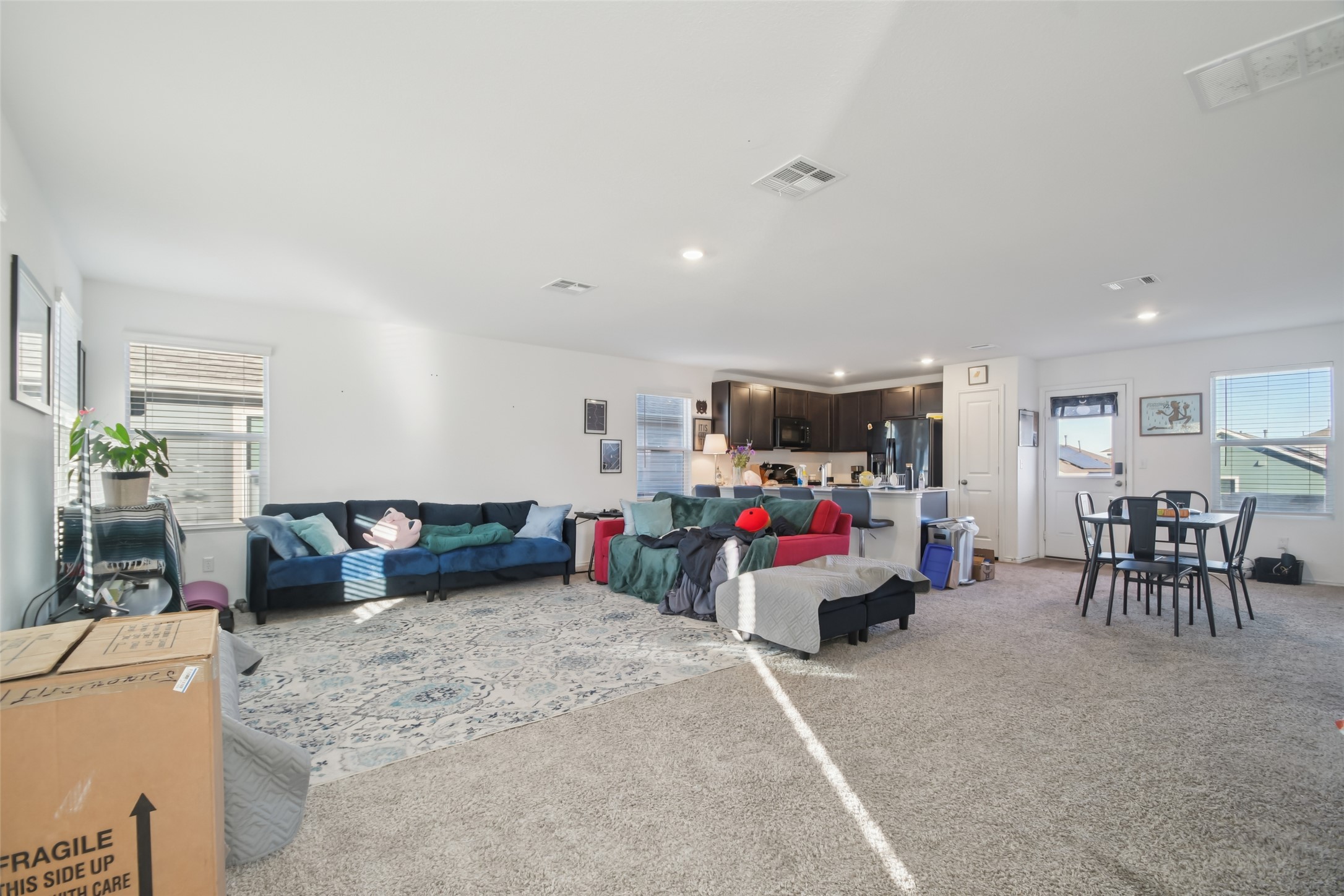 857 Powell Kyle, TX 78640 - Photo 4 of 28 Living area with healthy amount of natural light, light colored carpet, and recessed lighting