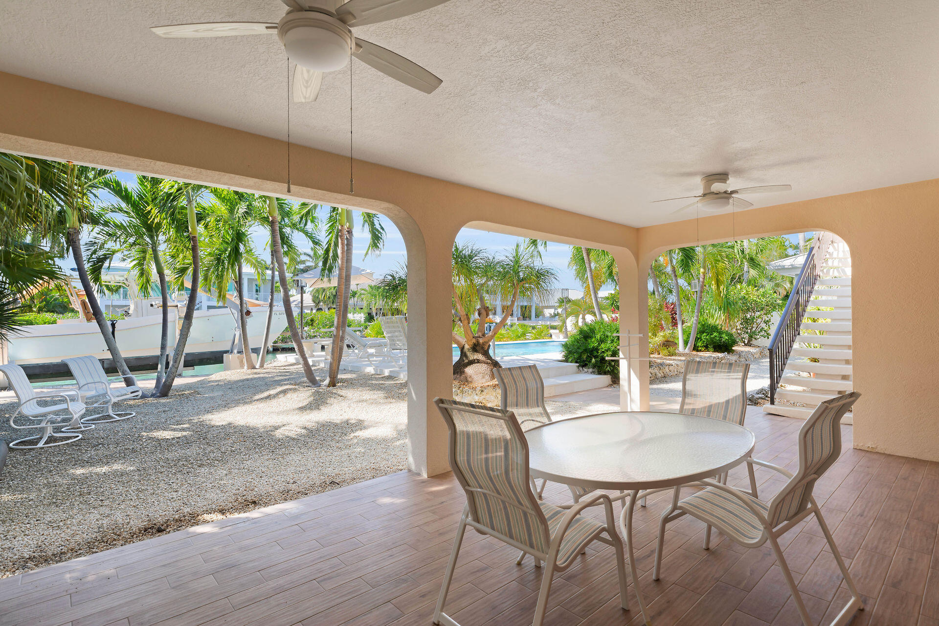 701 12th Street Key Colony Beach, FL 33051 - Photo 12 of 48 a view of a dining room with furniture large windows and wooden floor
