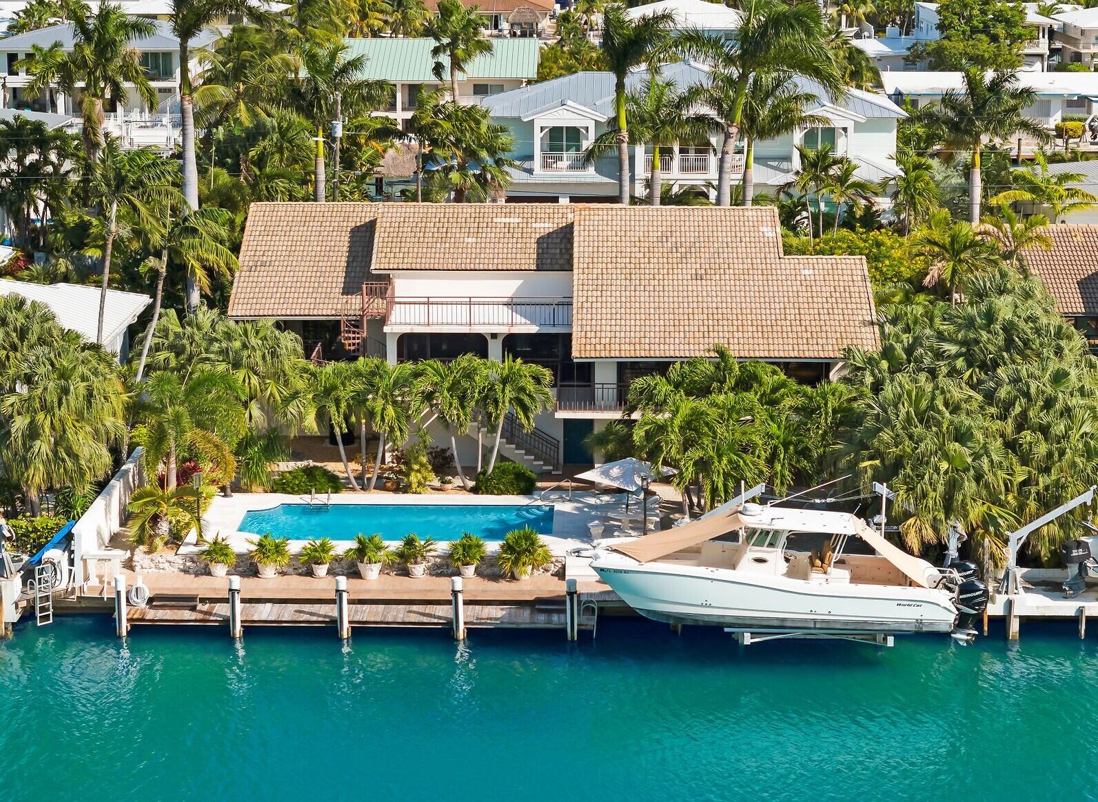 701 12th Street Key Colony Beach, FL 33051 - Photo 2 of 48 an aerial view of a house with a garden and lake view