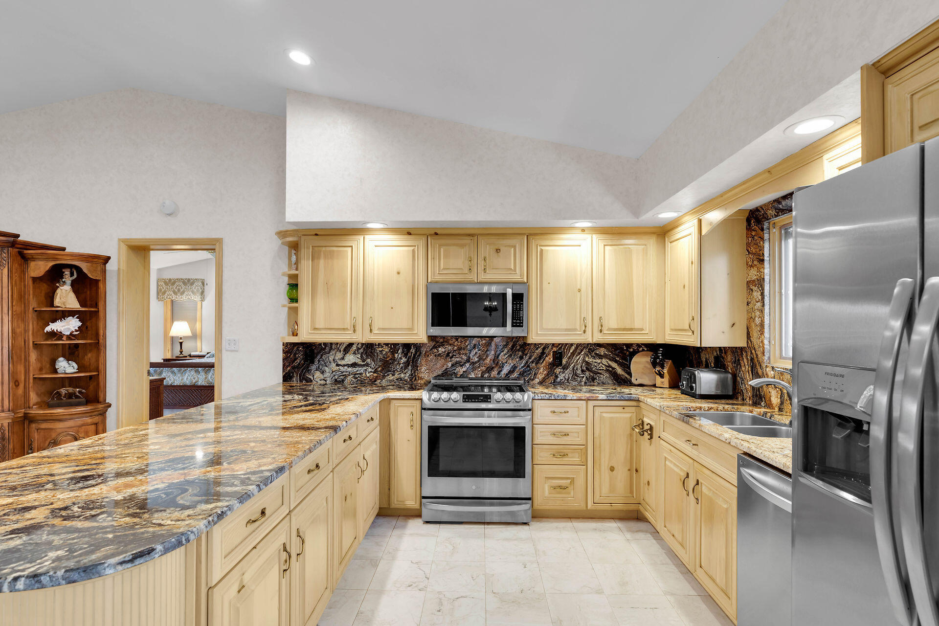701 12th Street Key Colony Beach, FL 33051 - Photo 22 of 48 a large kitchen with a stove top oven and refrigerator