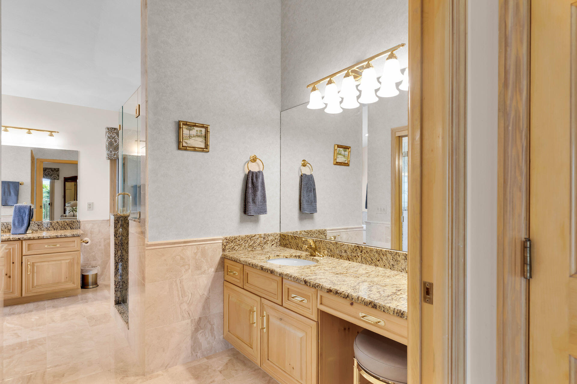701 12th Street Key Colony Beach, FL 33051 - Photo 28 of 48 a bathroom with a granite countertop sink a mirror and a bath tub