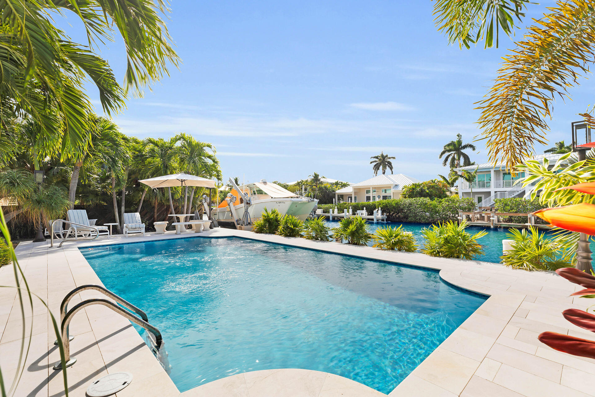 701 12th Street Key Colony Beach, FL 33051 - Photo 8 of 48 a swimming pool with outdoor seating and yard