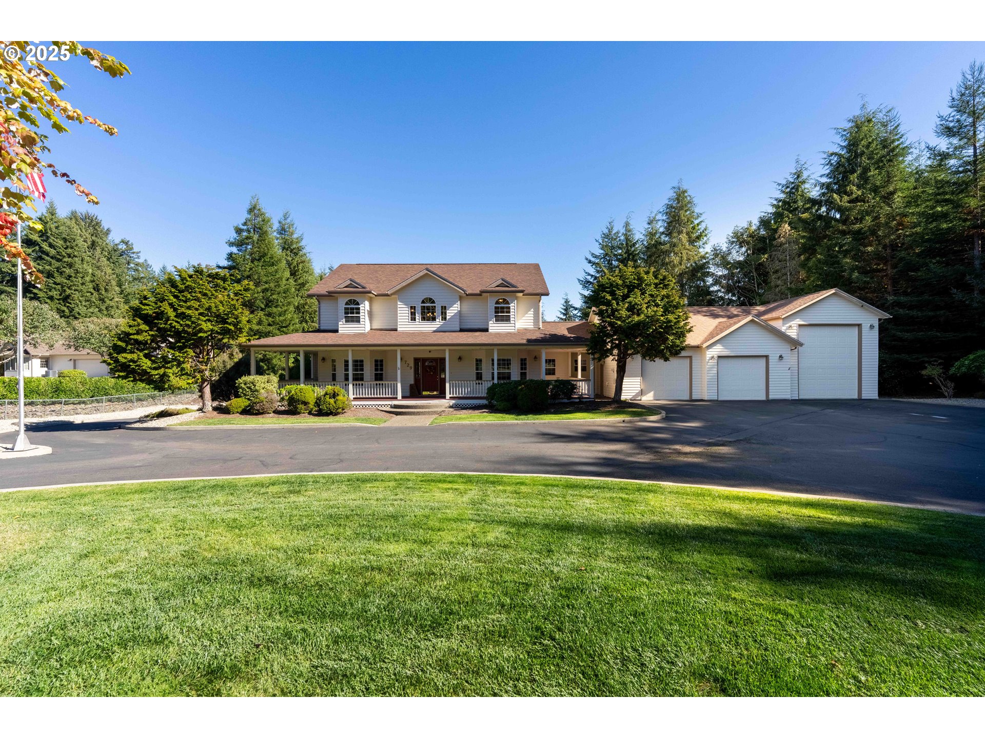 729 Ranch Road Reedsport, OR 97467 - Photo 3 of 48 a front view of house with yard and trees in the background