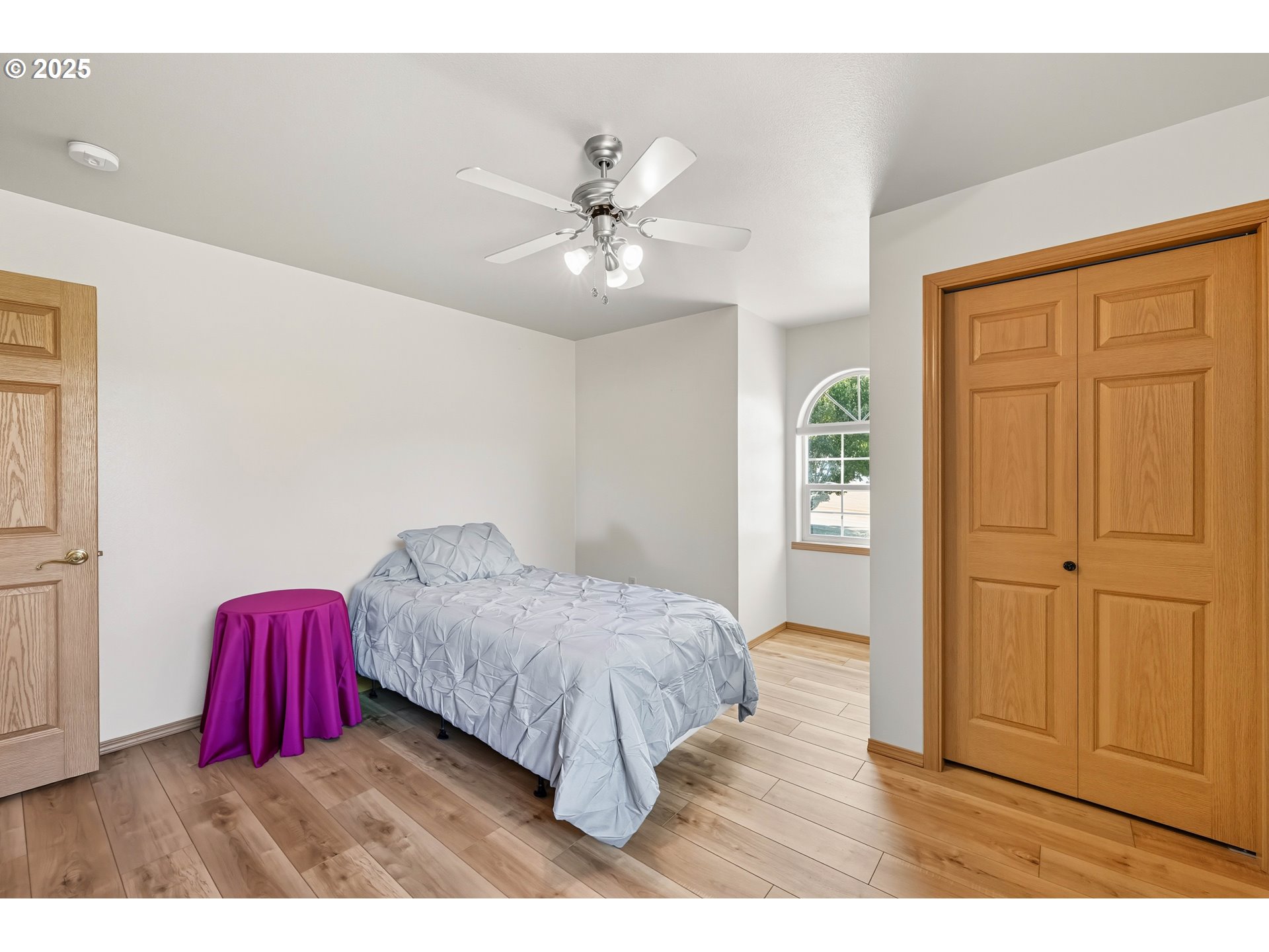 729 Ranch Road Reedsport, OR 97467 - Photo 42 of 48 a bedroom with a bed and a chandelier