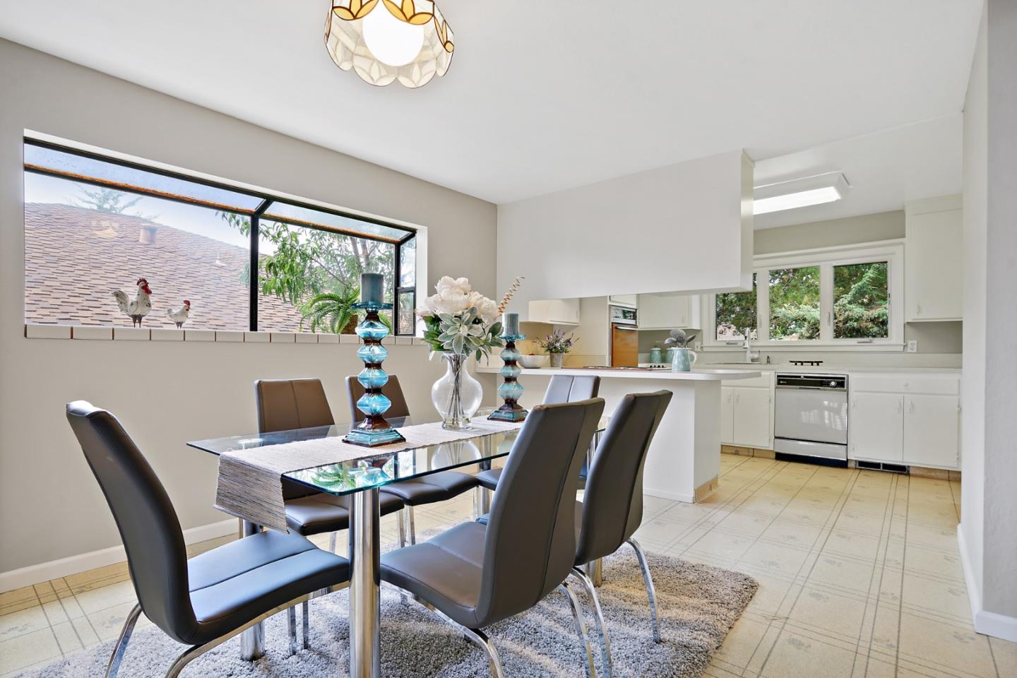 1511 Ridge Road Belmont, CA 94002 - Photo 18 of 50 a dining room with furniture a large window and a chandelier