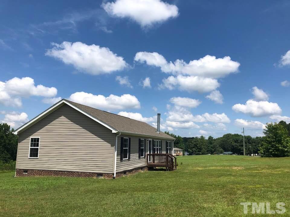 855 Chub Lake Loop Road Roxboro, NC 27574 - Photo 2 of 24 a view of a house with a yard