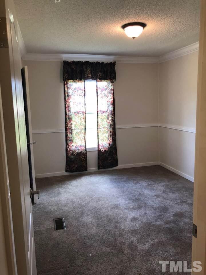 855 Chub Lake Loop Road Roxboro, NC 27574 - Photo 14 of 24 an empty room with windows