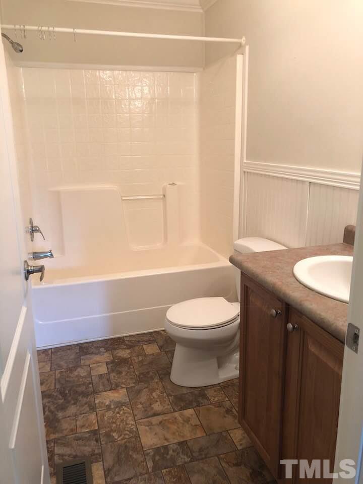 855 Chub Lake Loop Road Roxboro, NC 27574 - Photo 15 of 24 a bathroom with a sink a toilet and shower