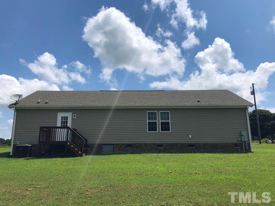 855 Chub Lake Loop Road Roxboro, NC 27574 - Photo 20 of 24 a backyard of a house with table and chairs